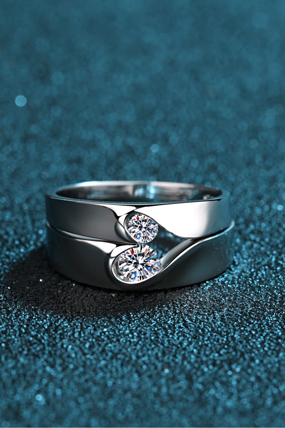 Rhodium-plated moissanite ring with sparkling gemstone, elegant jewelry piece showcasing intricate design and shine.