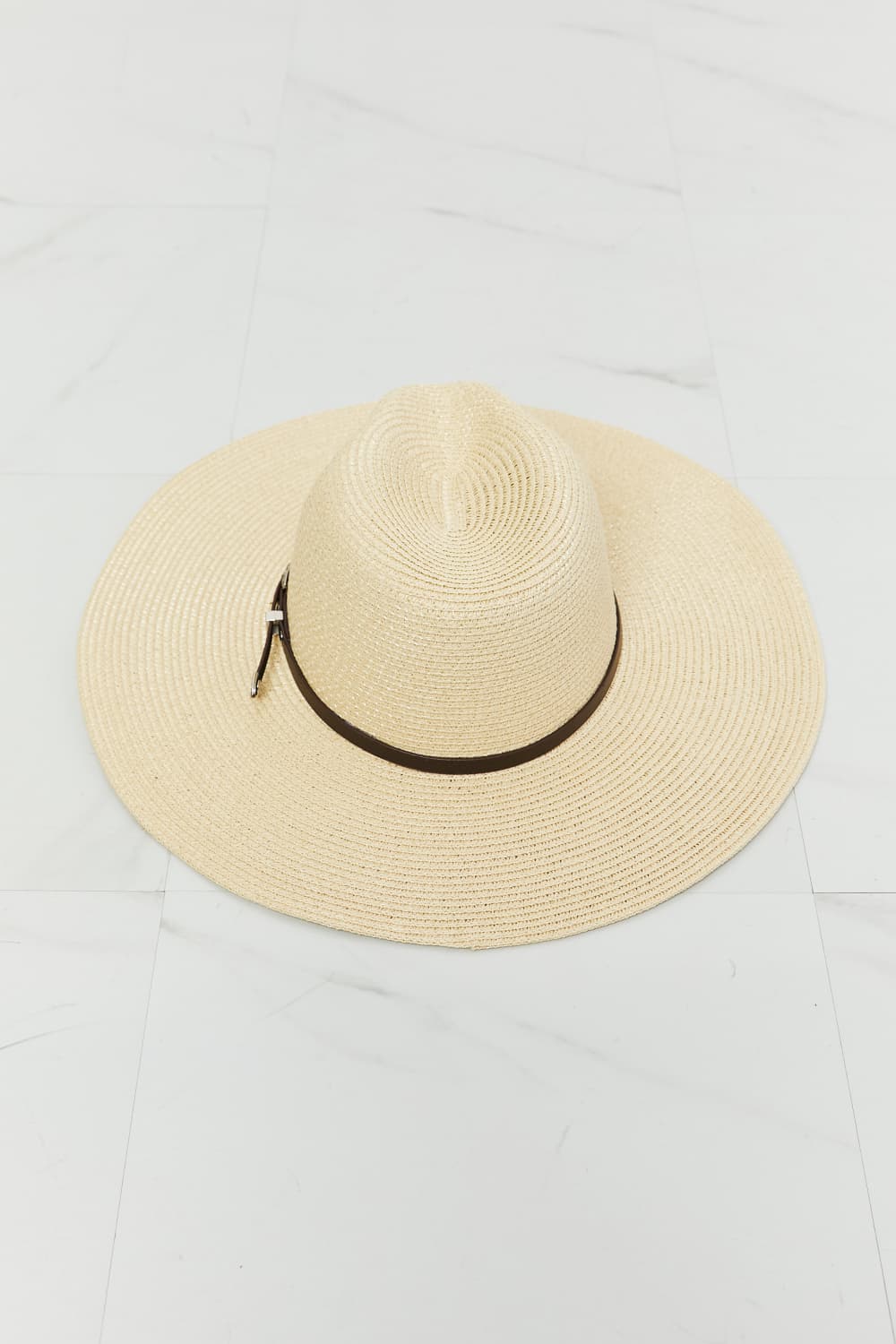 Fame Boho Summer Straw Fedora Hat by Trendsi with a wide brim and woven straw design, perfect for sunny outdoor wear.
