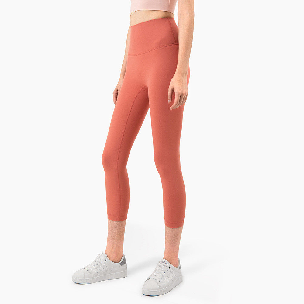 Peach Hips Fitness Cropped Leggings by Alvionz.com, close-up of peach-colored workout leggings with a fitted waistband and stretchy fabric.