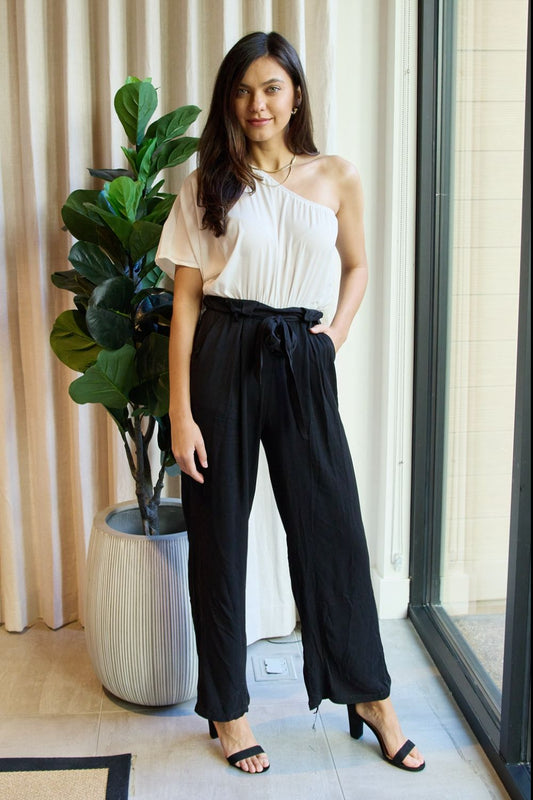 White and black one-shoulder jumpsuit from Trendsi's Dress Day Marvelous in Manhattan collection, stylish and elegant for any occasion.