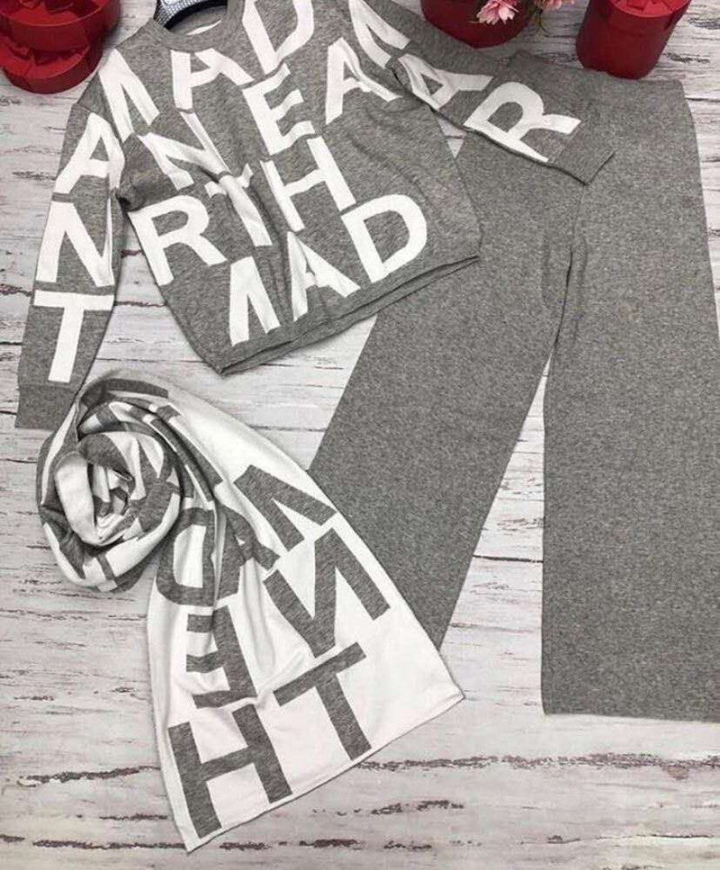 Black women's Agate sport winter suit with a cozy sweater, ideal for active outdoor winter activities.