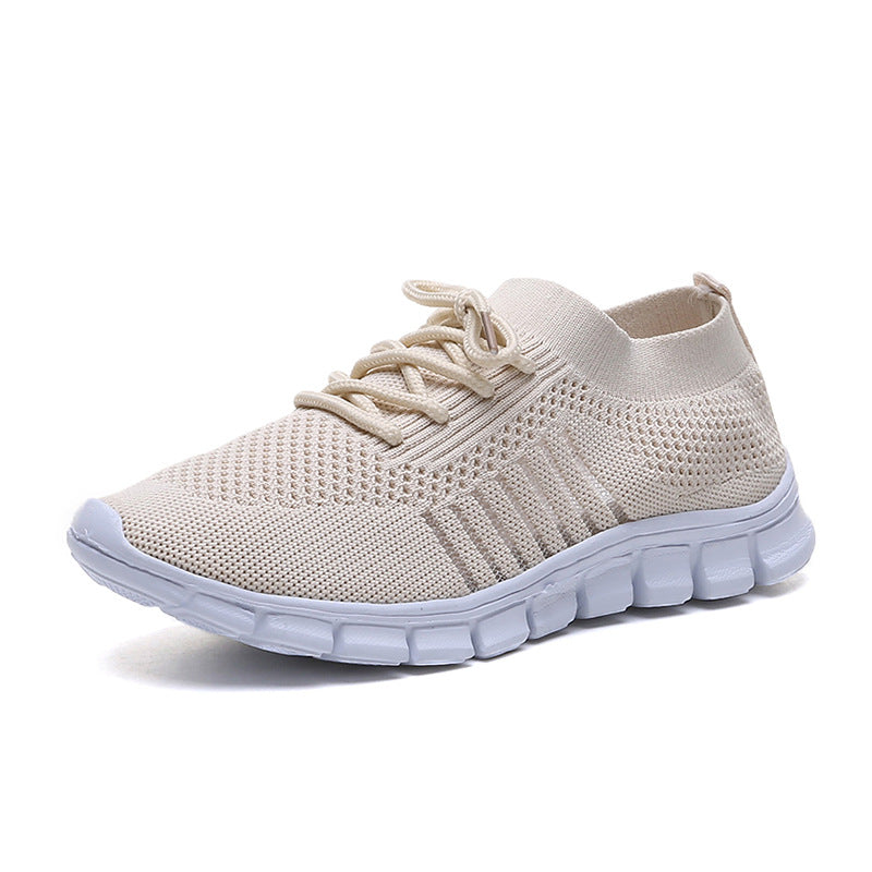 Beige breathable casual women's flying knit sports shoes by Agate, featuring flat design and comfortable slip-on style.