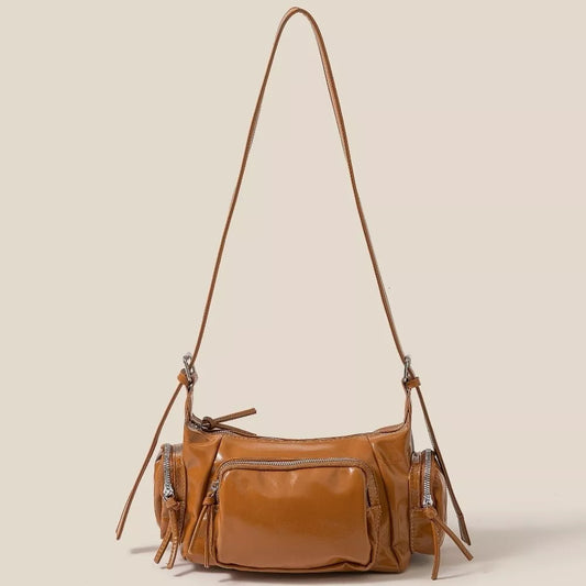Fame glossy faux leather multi-pocket handbag with gold hardware and top handles, stylish Trendsi fashion accessory.