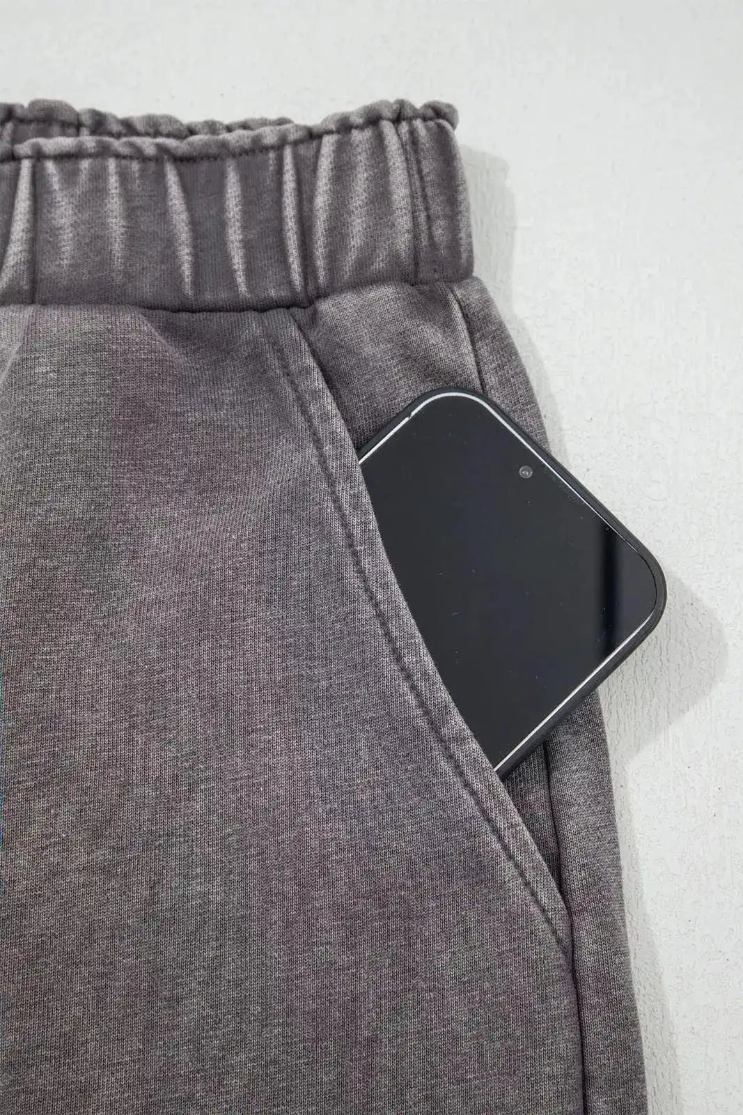 Dark gray mineral wash leopard patchwork loose pants from Trendsi, featuring a relaxed fit and stylish animal print design.