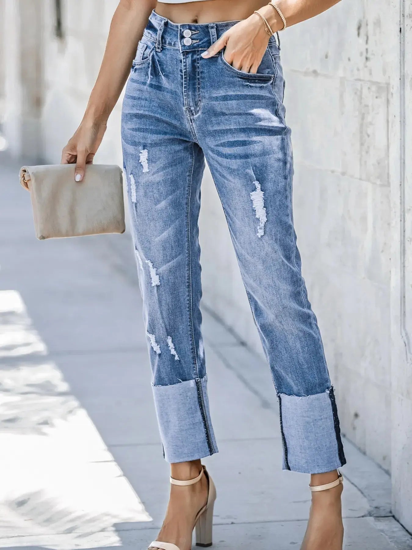 Light blue high waist distressed straight leg jeans by Trendsi, shown with a relaxed fit and ripped details.