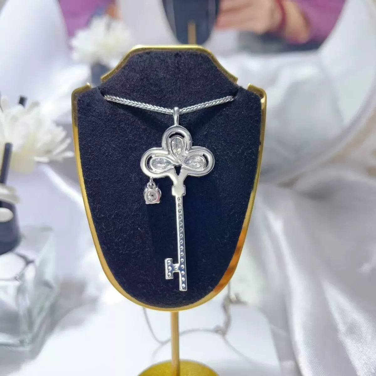 Sterling silver key necklace with a 3.5 carat moissanite gemstone, featuring a 925 sterling silver chain and elegant design.