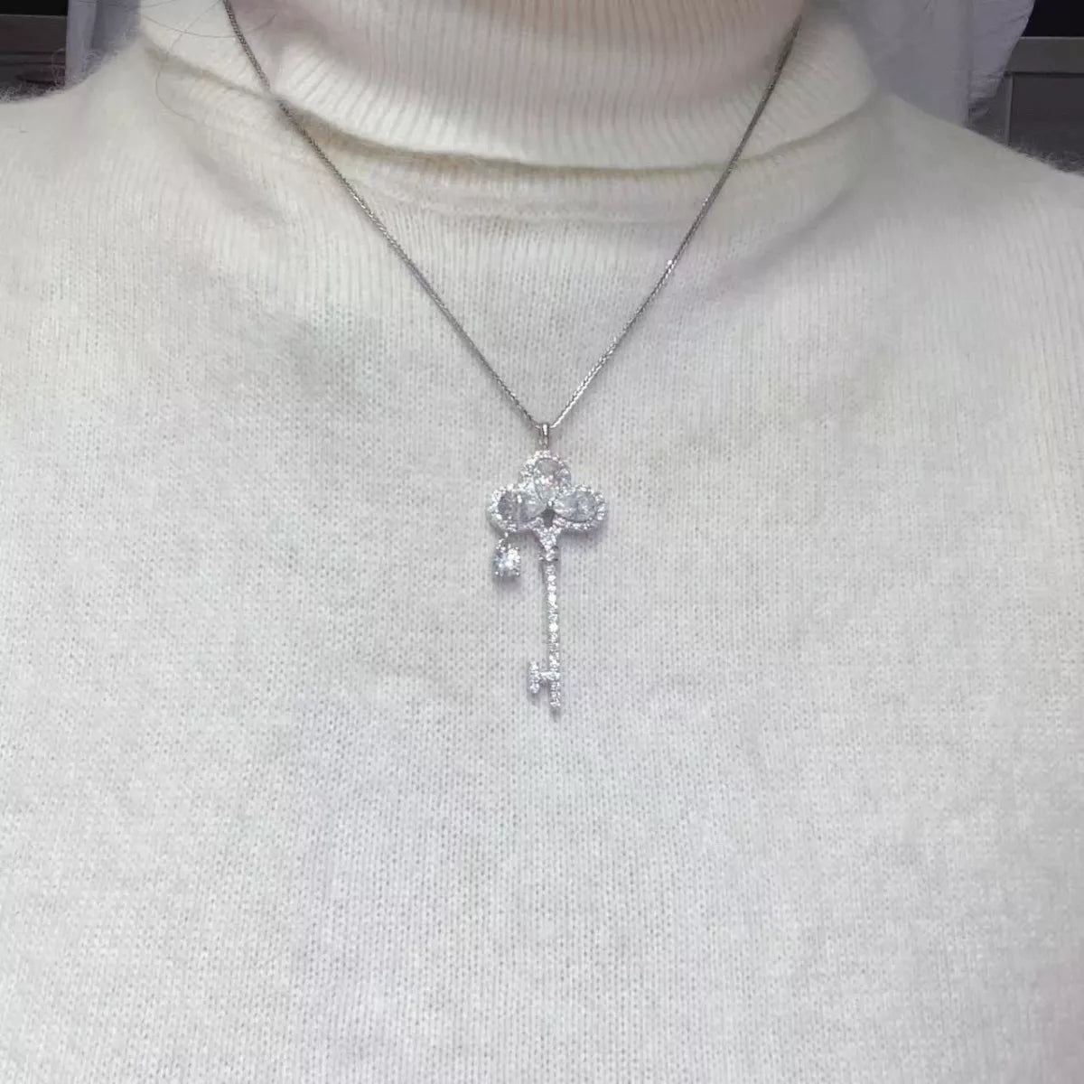 Sterling silver key necklace with 3.5 carat moissanite gemstone, featuring a sleek design and adjustable chain.