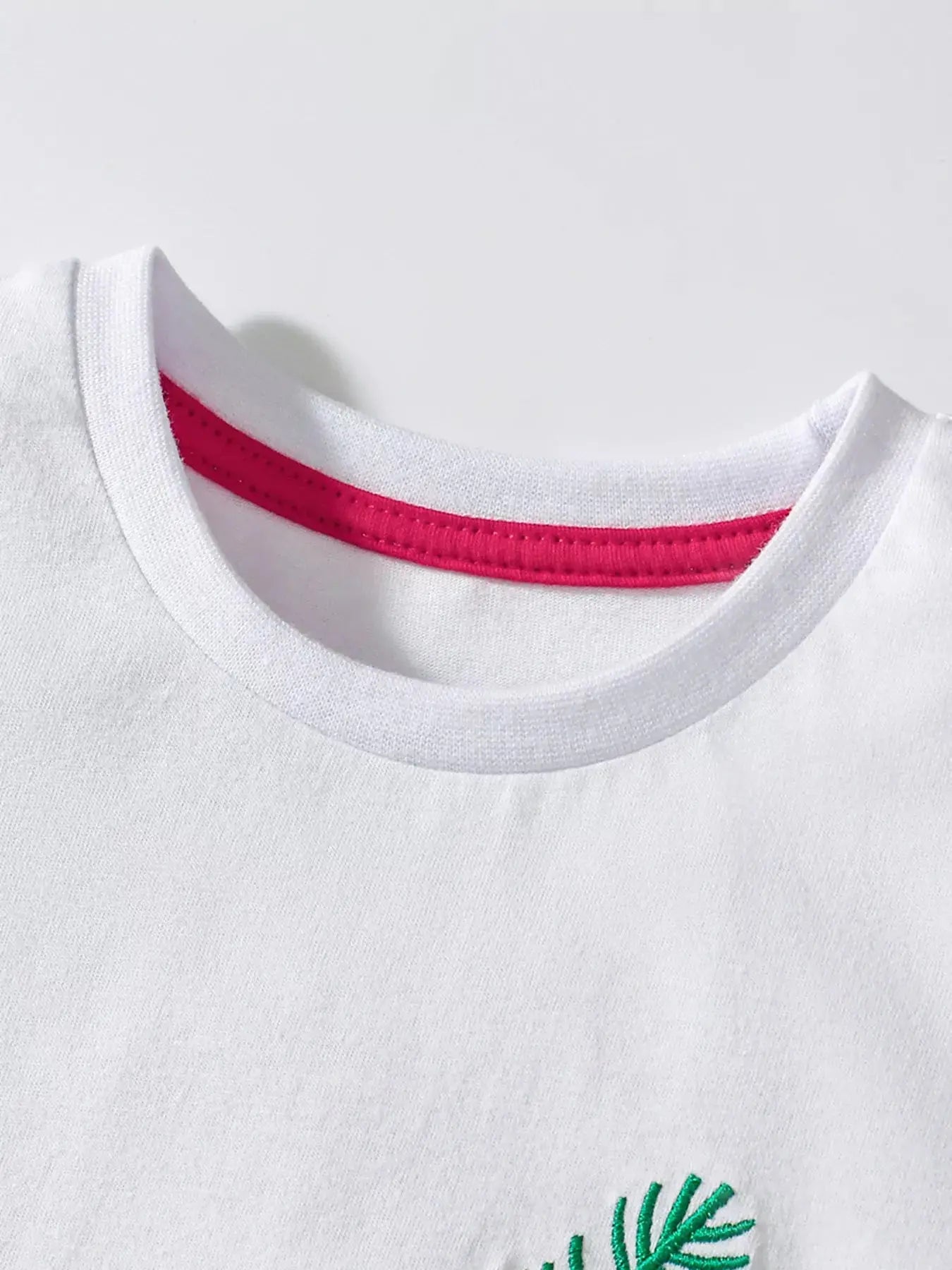 White children's animal print round neck T-shirt by Trendsi, featuring playful animal graphics for kids' casual wear.